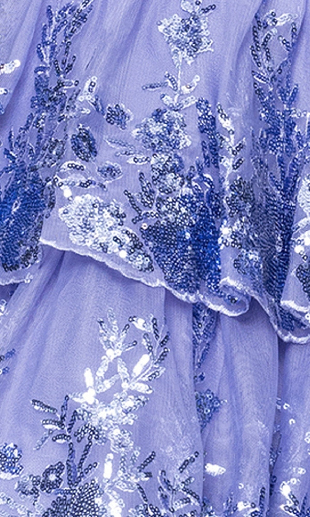 Close-up of the Blondie Nites 5702BN short prom dress featuring lavender sheer fabric with blue and silver floral sequin embroidery, layered ruffles, and elegant details perfect for a fit-and-flare style.